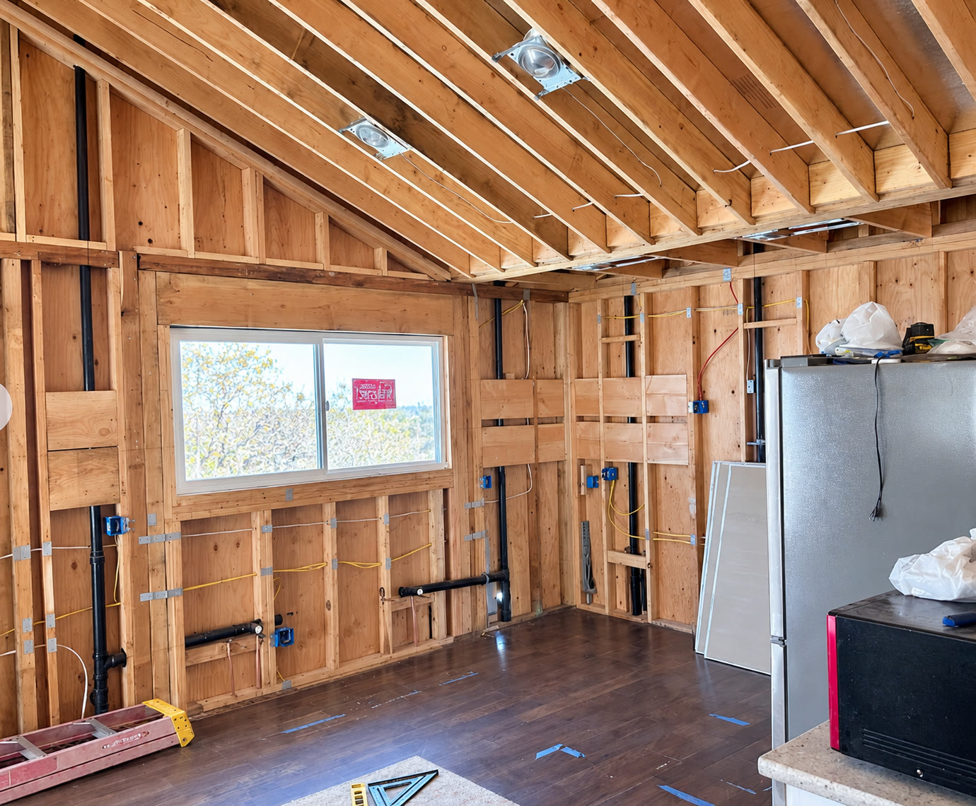 Exposed framing and rough-in work in a room under renovation