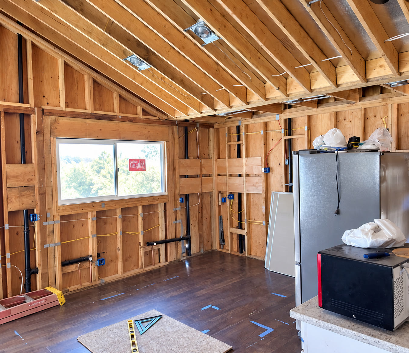 Wide view of interior framing, wiring and plumbing