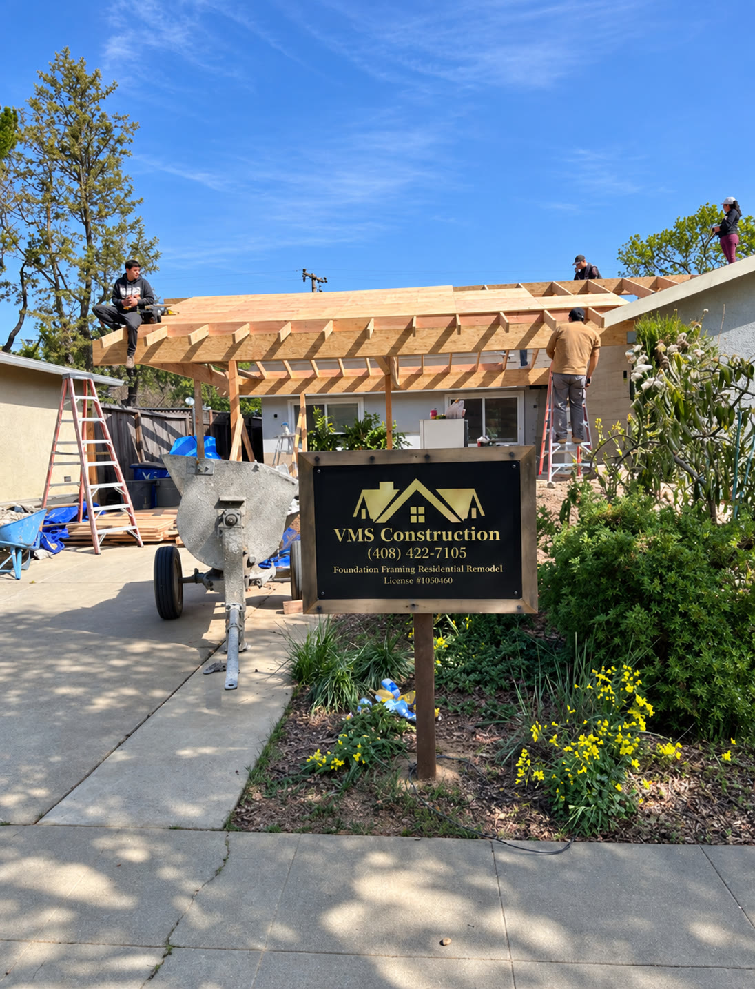 VMS Construction sign and crew working on roof framing