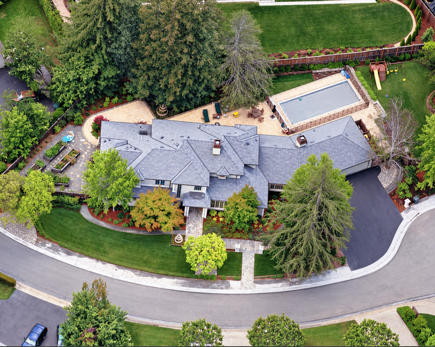 Aerial view of a residence, roofline and landscaped grounds