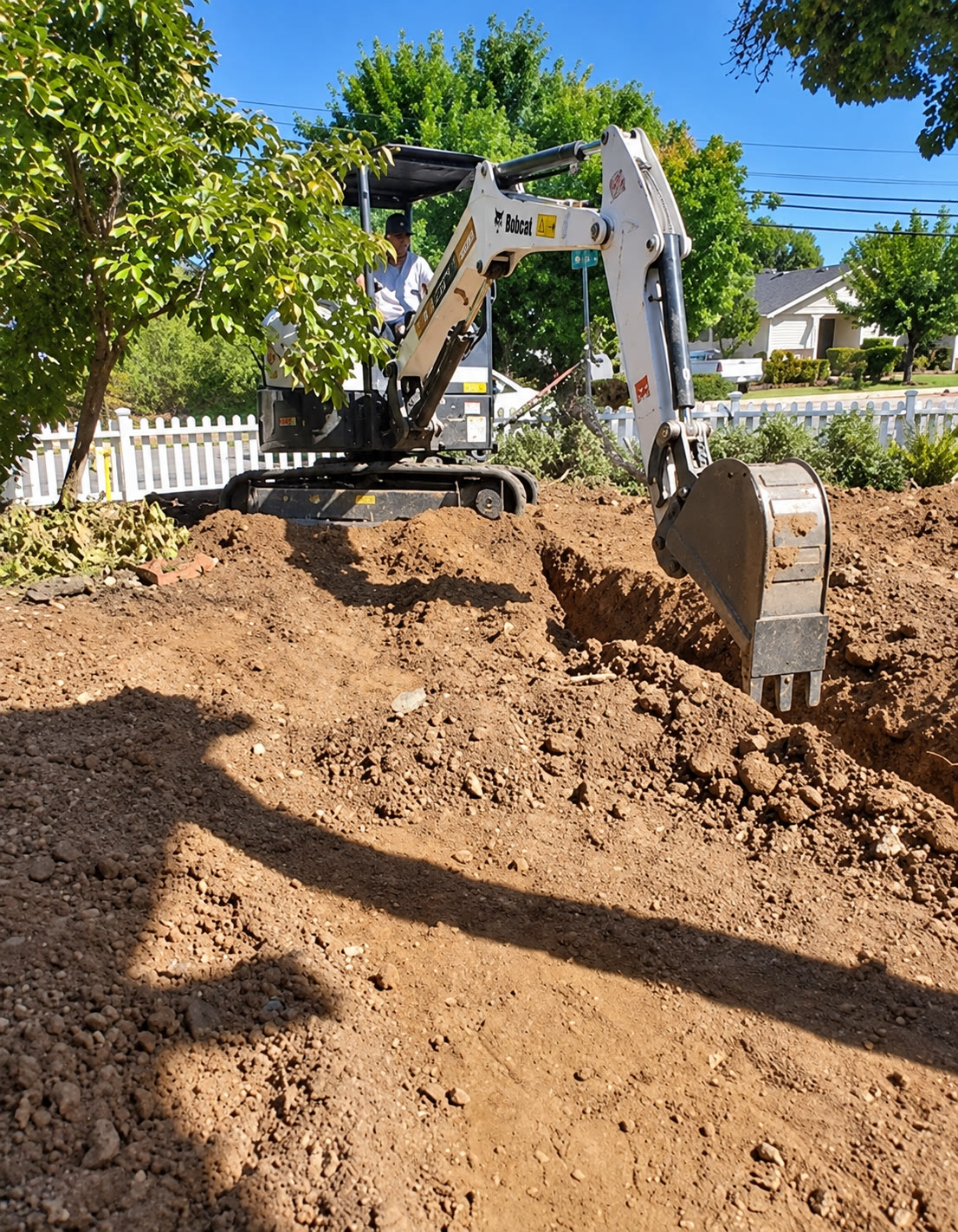 Excavator preparing a residential construction area