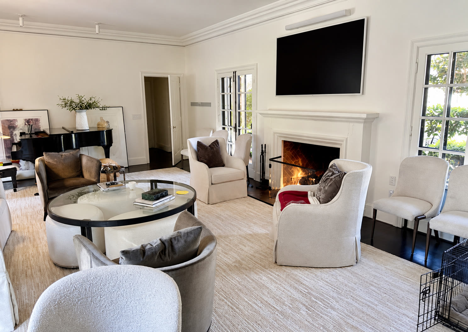 Finished living room with white fireplace and seating