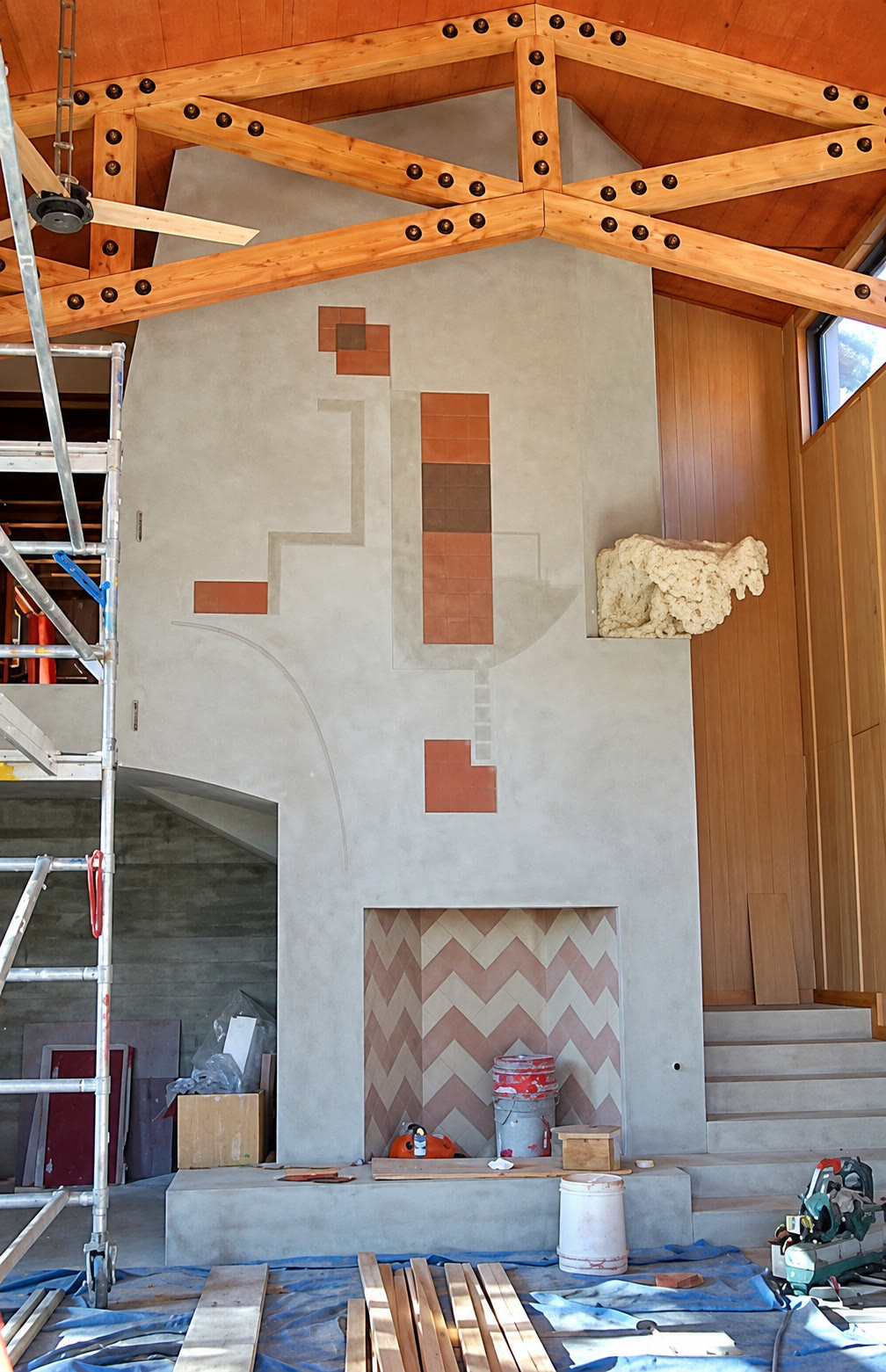Fireplace construction beneath exposed timber roof trusses