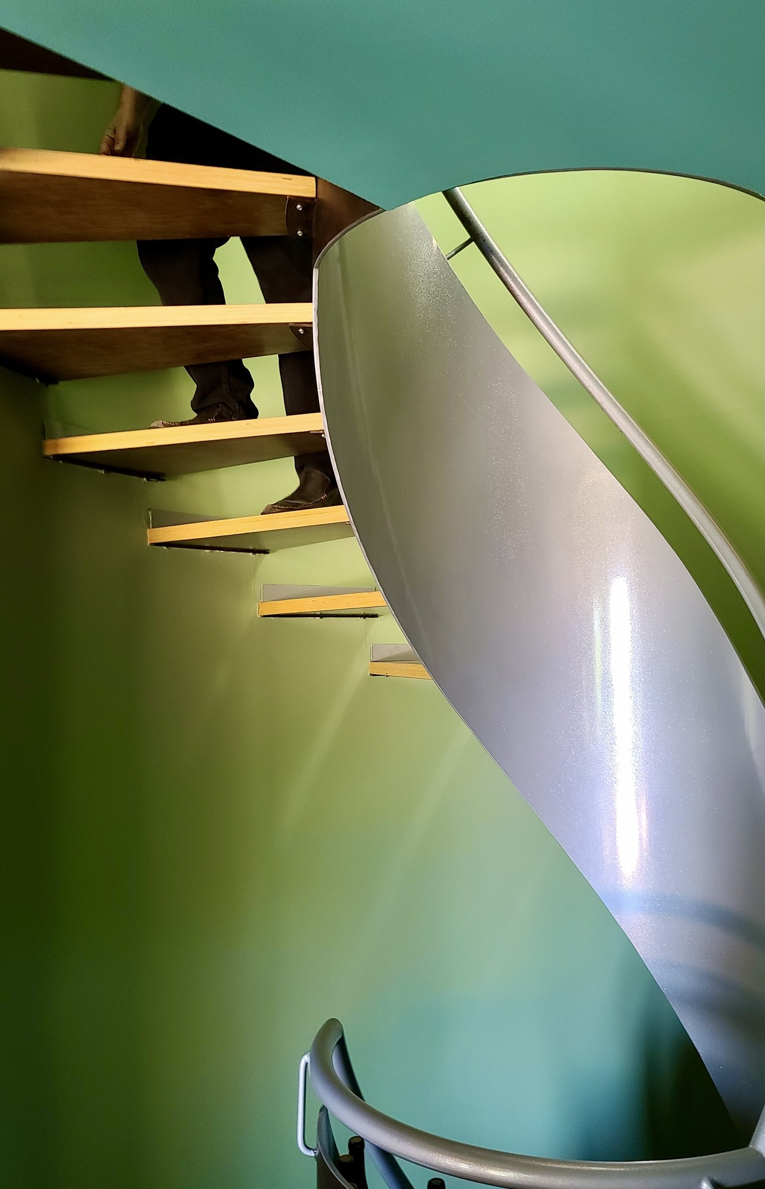 Sculptural curved staircase with distinctive metal detailing