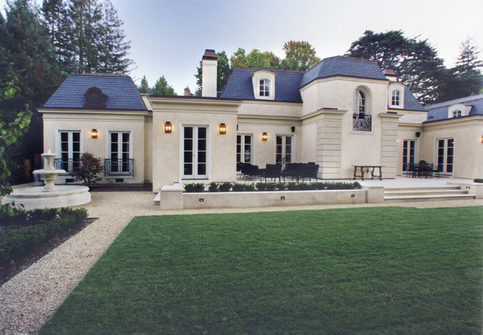 Custom residence with classical architectural details and landscaped grounds